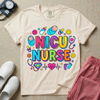 Cute retro NICU nurse design featuring colorful bubble lettering spelling NICU Nurse surrounded by swaddled babies, happy smiley faces, a baby bottle, pacifiers, heart stethoscopes, and an EKG heartbeat pulse graphic.
