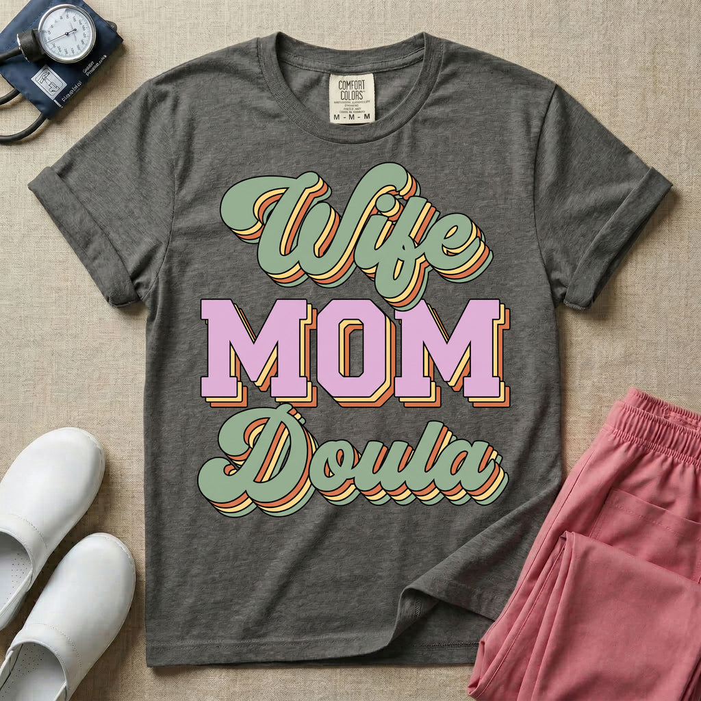 Retro birth worker design featuring stacked layered 3D lettering spelling Wife Mom Doula with vintage cursive script and collegiate block typography.