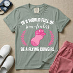 A humorous graphic tee for labor and delivery nurses featuring an illustration of a peanut ball wearing a cowboy hat, framed by laurel branches, along with the text "IN A WORLD FULL OF semi-fowlers BE A FLYING COWGIRL".