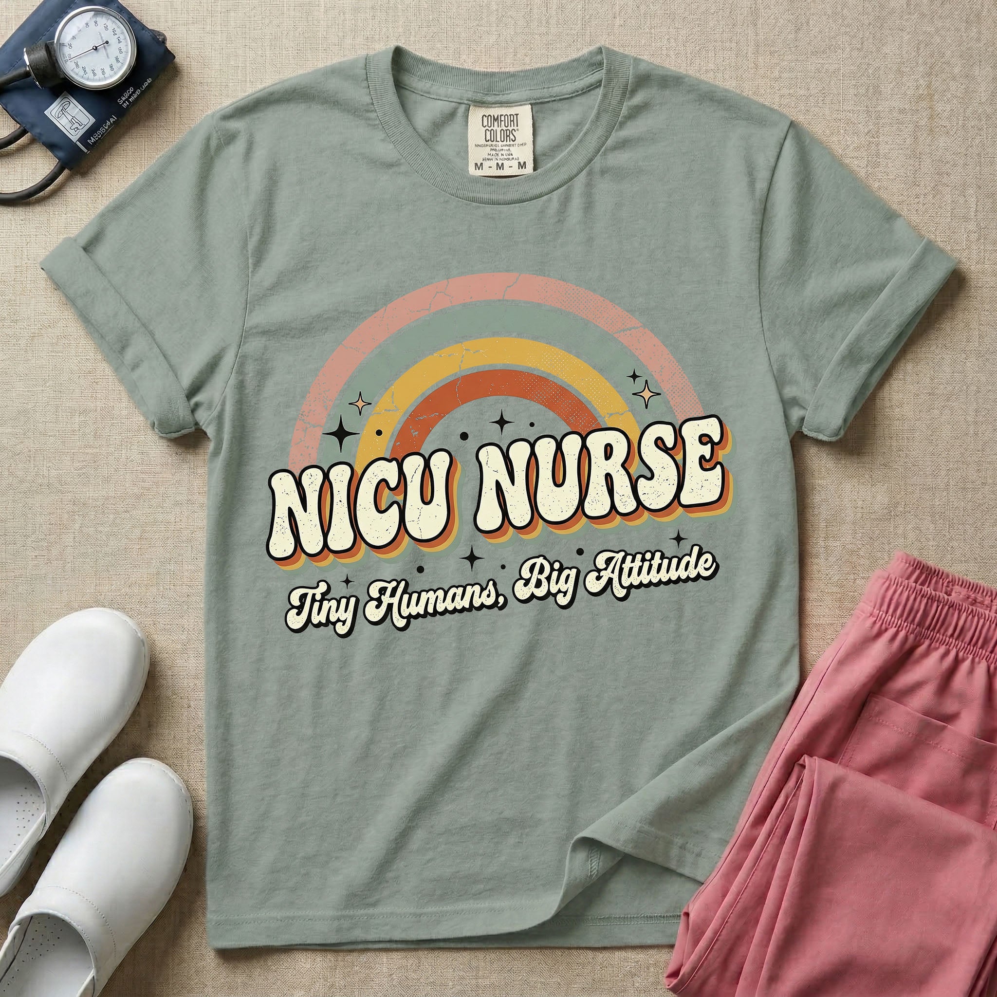 Neonatal Intensive Care Unit NICU nurse t-shirt with a retro vintage rainbow and tiny humans big attitude graphic in bay color.