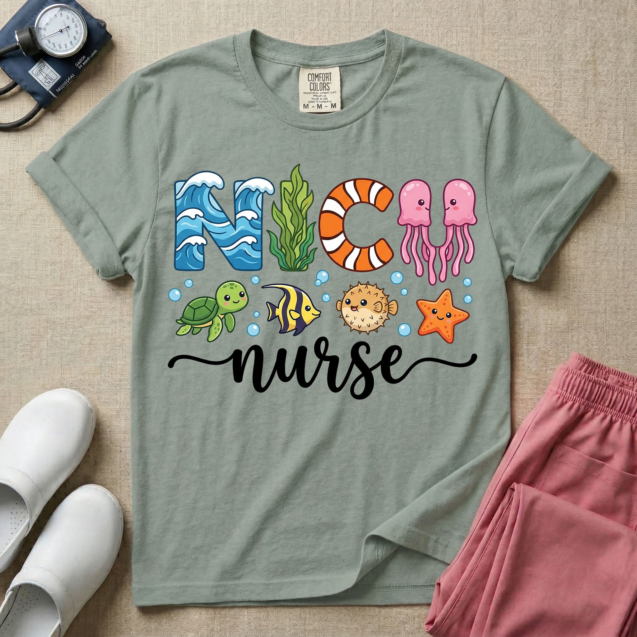A cute t-shirt for NICU nurses featuring the text "NICU nurse" where the letters are designed with ocean elements like waves, seaweed, and a jellyfish, surrounded by under the sea creatures including a sea turtle, tropical fish, pufferfish, and starfish.