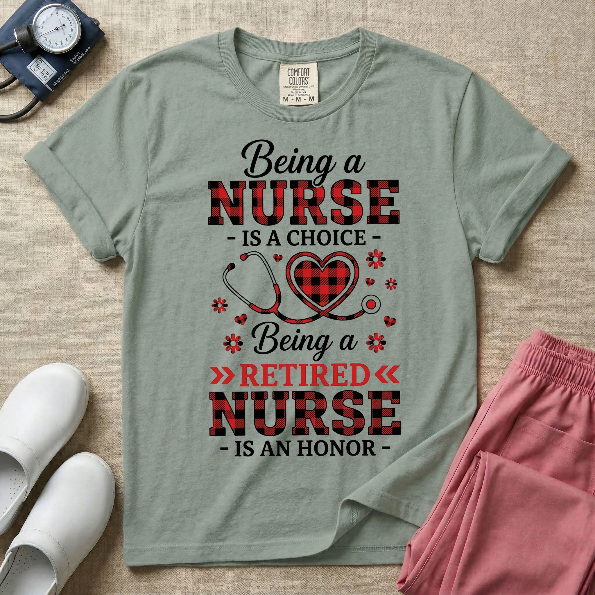 A t-shirt featuring the text Being a NURSE IS A CHOICE Being a RETIRED NURSE IS AN HONOR surrounding a central graphic of a red and black buffalo plaid heart intertwined with a stethoscope.