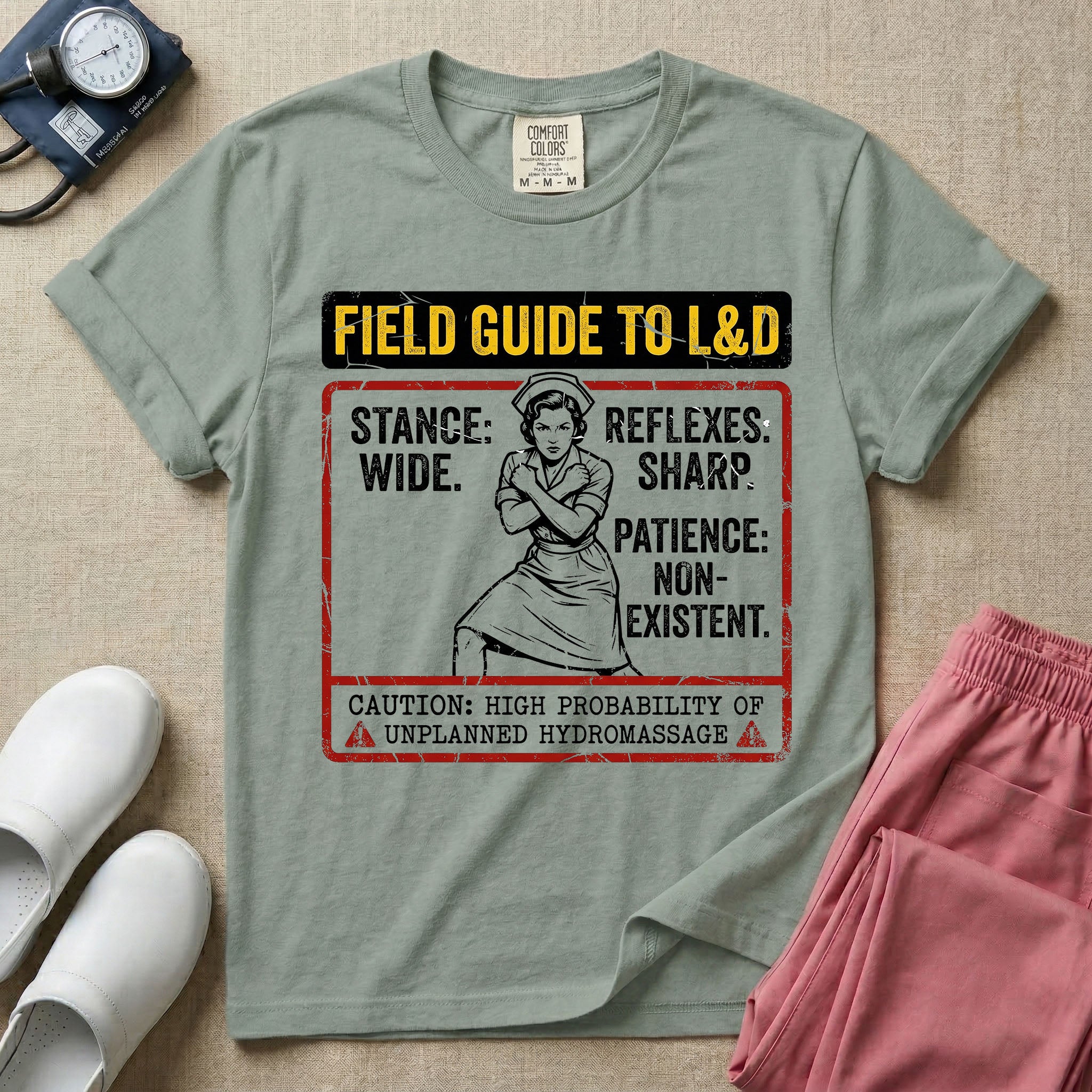 A humorous and retro graphic tee for labor and delivery nurses featuring a vintage nurse illustration alongside the text "FIELD GUIDE TO L&D", "STANCE: WIDE", "REFLEXES: SHARP", "PATIENCE: NON-EXISTENT", and "CAUTION: HIGH PROBABILITY OF UNPLANNED HYDROMASSAGE".