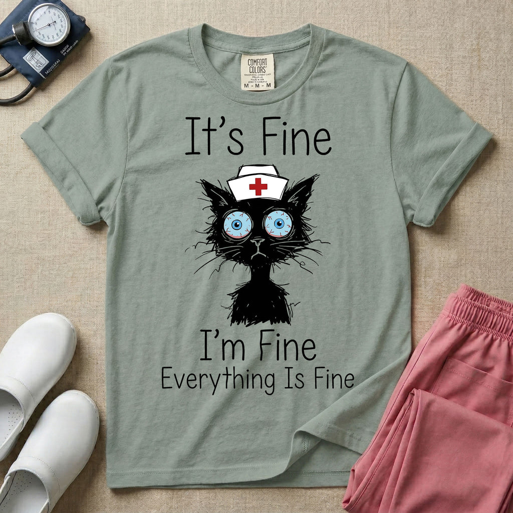 General nursing t-shirt featuring a humorous graphic of a frazzled black cat wearing a medical cross nurse cap alongside the text "It's Fine I'm Fine Everything Is Fine".