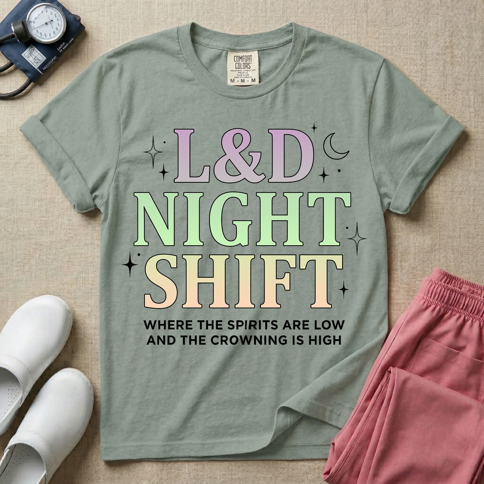 Labor and Delivery L&D night shift nurse t-shirt with pastel typography where the spirits are low and the crowning is high graphic in bay color.