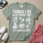 A t-shirt featuring the text THINGS I DO IN MY SPARE TIME AS A NURSING STUDENT surrounded by humorous line-art icons depicting studying, drinking coffee, and lacking sleep.