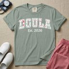 A personalized Doula graphic featuring the word DOULA in large, arched varsity-style letters filled with a delicate pink and green floral pattern, positioned above customizable text that reads Est. 2026.
