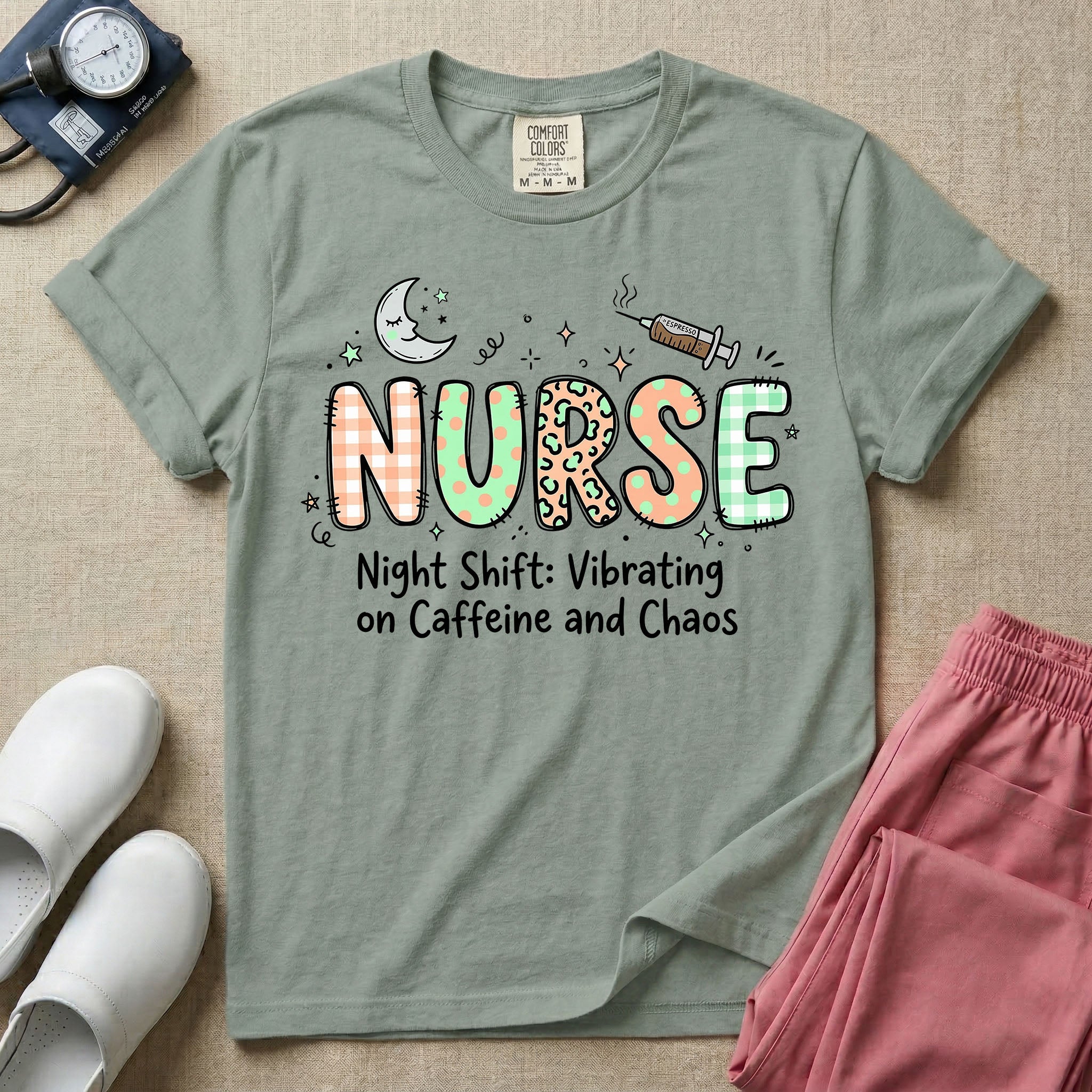 A humorous General Nursing graphic featuring the word NURSE in large, playfully patterned letters including plaid, leopard print, and floral designs, accented by a sleeping crescent moon and a syringe, positioned above text that reads Night Shift: Vibrating on Caffeine and Chaos.