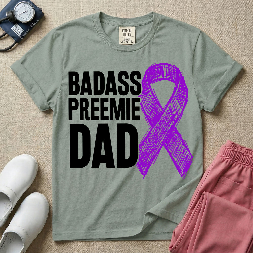 A graphic for the Neonatal Intensive Care Unit featuring the stacked, bold white text 'BADASS PREEMIE DAD' next to a large, textured purple awareness ribbon.