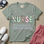 A humorous t-shirt for nurses featuring the word "NURSE" in colorful boho patterned letters above the funny phrase "I've Been Peed On by Better People Than You", surrounded by small abstract floral shapes.