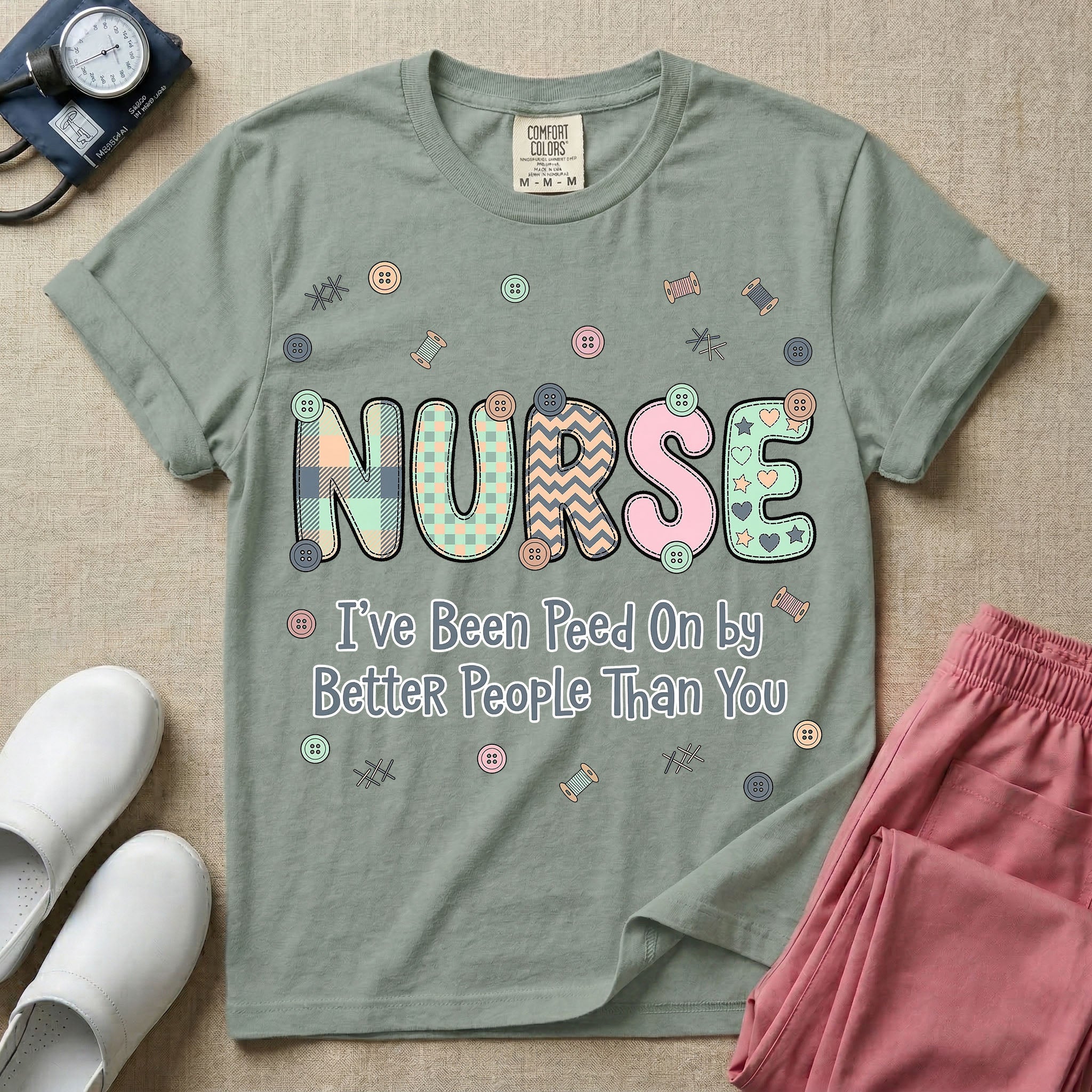 A humorous t-shirt for nurses featuring the word "NURSE" in colorful boho patterned letters above the funny phrase "I've Been Peed On by Better People Than You", surrounded by small abstract floral shapes.