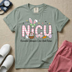 Neonatal Intensive Care Unit NICU nursing t-shirt featuring the letters NICU in a pink plaid pattern with bunny ears on the I, alongside a basket and Easter eggs, positioned above the cursive text "Neonatal Intensive Care Unit Nurse".