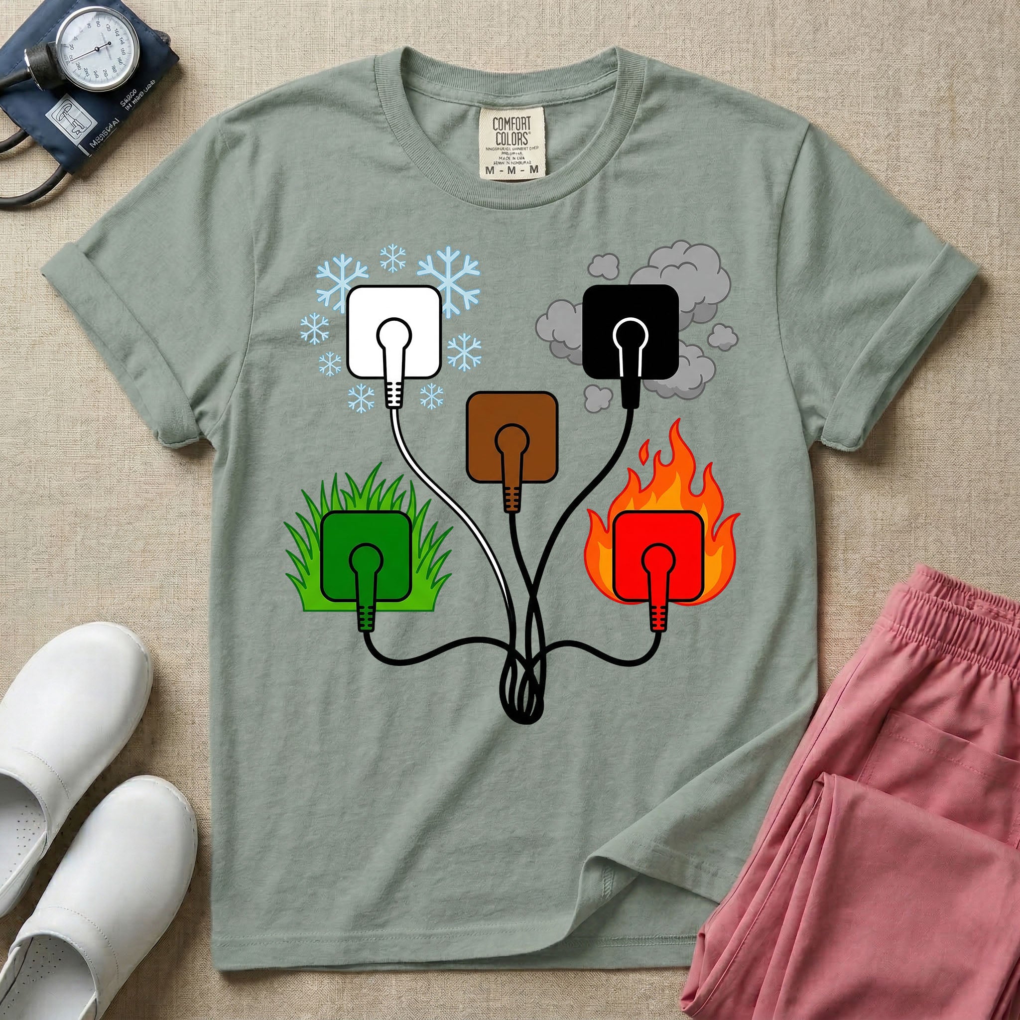 A minimalist t-shirt for nurses featuring an ECG lead placement mnemonic graphic with five connected electrical plugs, illustrating white snow over green grass, black smoke over red fire, and a central brown plug.