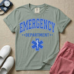 A classic varsity-style t-shirt for emergency room nurses featuring the word "EMERGENCY" in a large, arched blue collegiate font above the word "DEPARTMENT", centered over a blue Star of Life medical symbol.