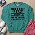 Funny Being A Nurse Is Easy Bike On Fire Sarcastic Nurse Sweatshirt - Seafoam Comfort Colors Sweatshirt | HugTee