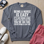 Funny Being A Nurse Is Easy Bike On Fire Sarcastic Nurse Sweatshirt - Blue Jean Comfort Colors Sweatshirt | HugTee