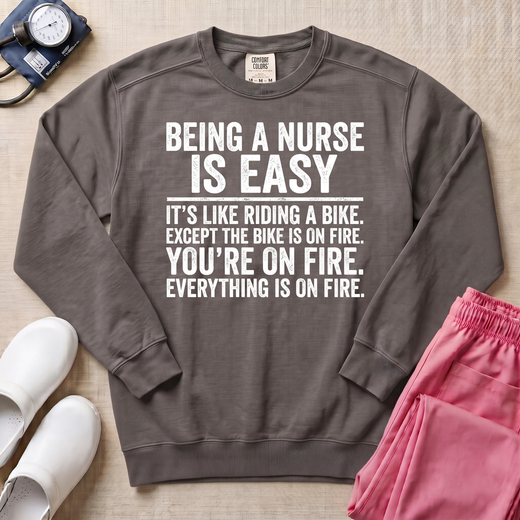 Funny Being A Nurse Is Easy Bike On Fire Sarcastic Nurse Sweatshirt - Pepper Lifestyle Hero Mockup | HugTee