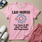 A humorous Labor and Delivery nurse t-shirt featuring a cervical dilation chart graphic highlighting 10cm, with the text "L&D NURSE" at the top and "I've Seen It All And I'm Still Not Impressed" at the bottom.