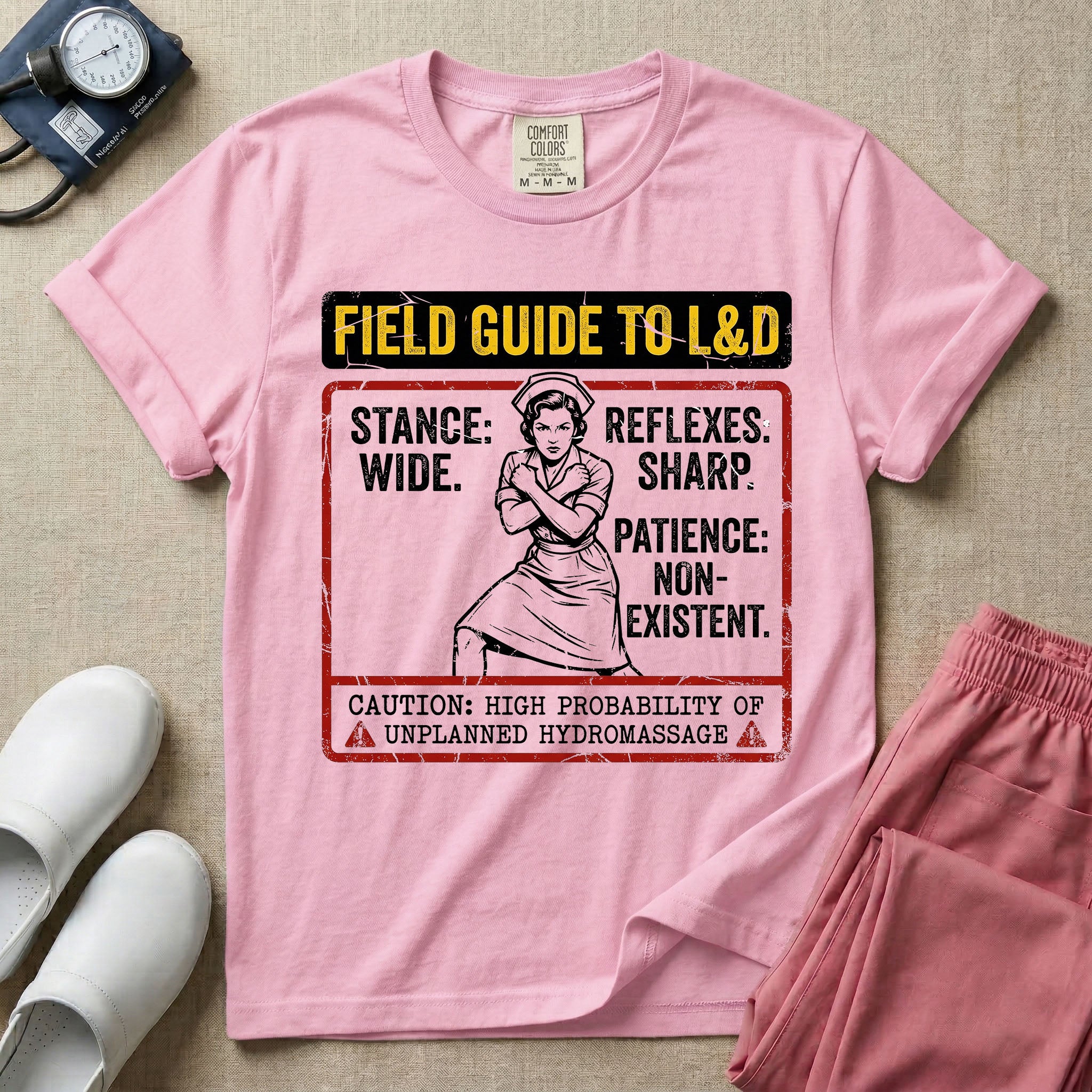 A humorous and retro graphic tee for labor and delivery nurses featuring a vintage nurse illustration alongside the text "FIELD GUIDE TO L&D", "STANCE: WIDE", "REFLEXES: SHARP", "PATIENCE: NON-EXISTENT", and "CAUTION: HIGH PROBABILITY OF UNPLANNED HYDROMASSAGE".