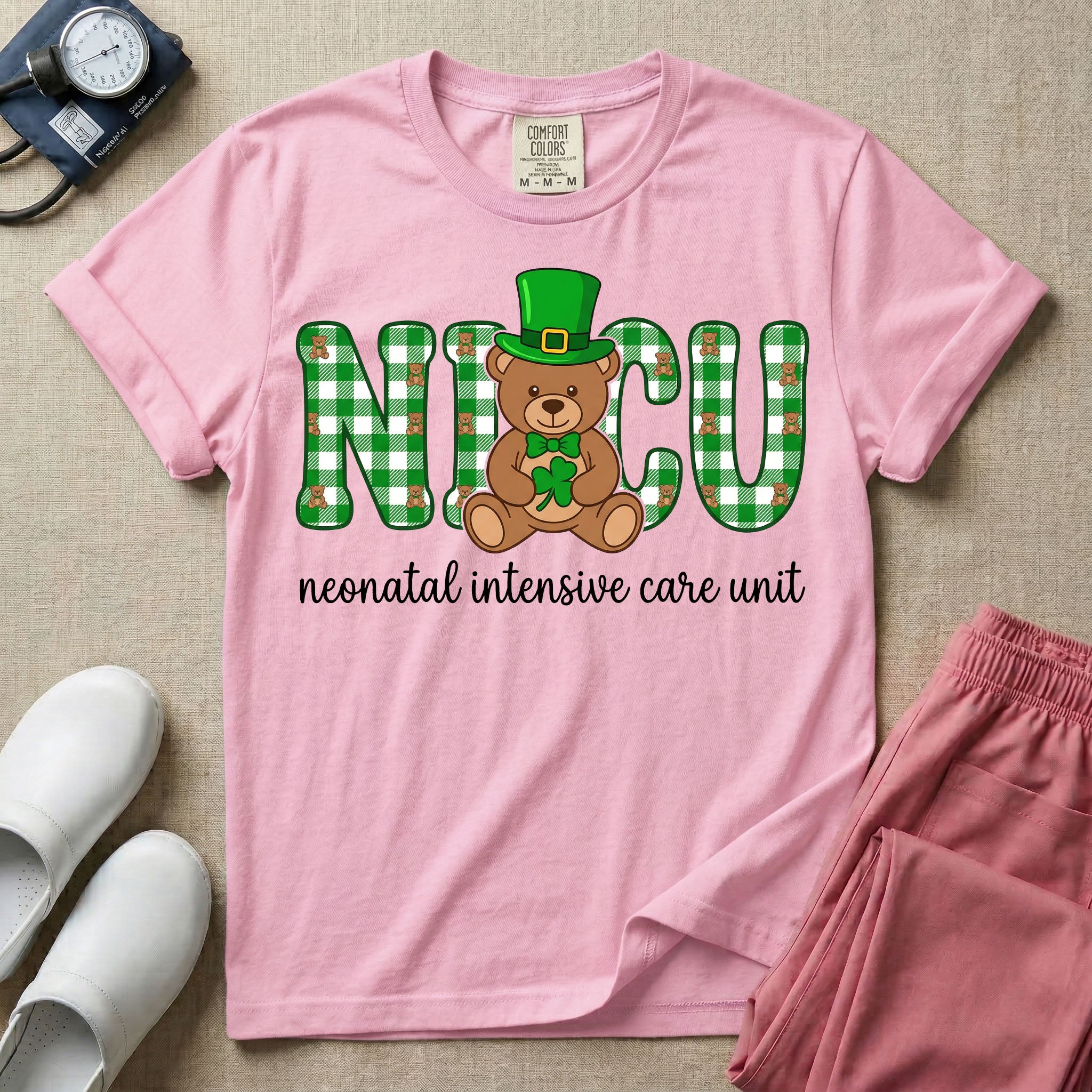 A graphic for a Neonatal Intensive Care Unit featuring the word 'NICU' in green and white plaid patterned letters, with a cute brown teddy bear wearing a leprechaun hat and holding a shamrock sitting in the middle, and the cursive text 'neonatal intensive care unit' underneath.