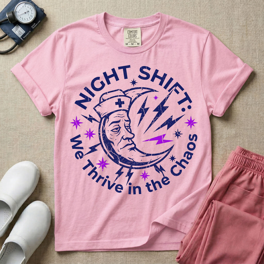 General nursing night shift nurse t-shirt with a retro purple moon wearing a nurse cap and we thrive in the chaos graphic in blossom color.
