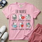 A funny t-shirt for emergency room nurses featuring the text "ER NURSE" above a grid of six cute cartoon cats demonstrating medical puns, including a cat reading for "PAWTHOLOGY", a cat with an ECG heart for "MEOWTABOLISM", a cat holding a test tube for "LAB PAWNELS", a cat with pills for "MEOWDICATION", a cat holding a heart for "HEALING PAWS", and a cat with a stethoscope for "PURRCEDURES".