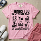 A t-shirt featuring the text THINGS I DO IN MY SPARE TIME AS A NURSING STUDENT surrounded by humorous line-art icons depicting studying, drinking coffee, and lacking sleep.