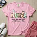 A humorous General Nursing graphic featuring the word NURSE in large, playfully patterned letters including plaid, leopard print, and floral designs, accented by a sleeping crescent moon and a syringe, positioned above text that reads Night Shift: Vibrating on Caffeine and Chaos.