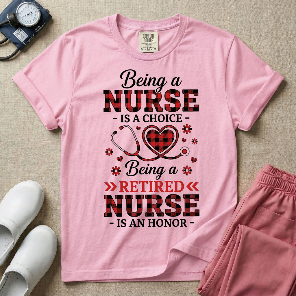 A t-shirt featuring the text Being a NURSE IS A CHOICE Being a RETIRED NURSE IS AN HONOR surrounding a central graphic of a red and black buffalo plaid heart intertwined with a stethoscope.