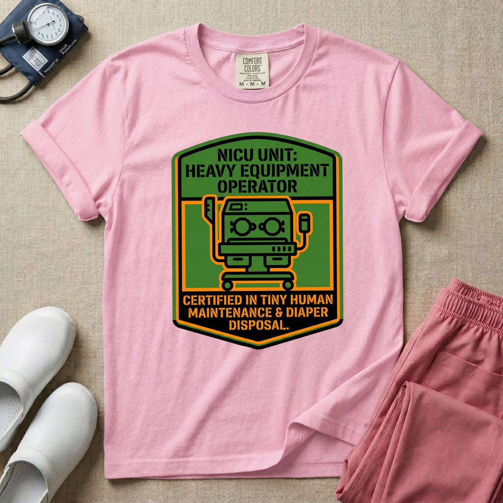 A graphic resembling a patch with green borders and orange inner sections featuring an illustration of a medical incubator in the center, with the text 'NICU UNIT: HEAVY EQUIPMENT OPERATOR' at the top and 'CERTIFIED IN TINY HUMAN MAINTENANCE & DIAPER DISPOSAL' at the bottom.