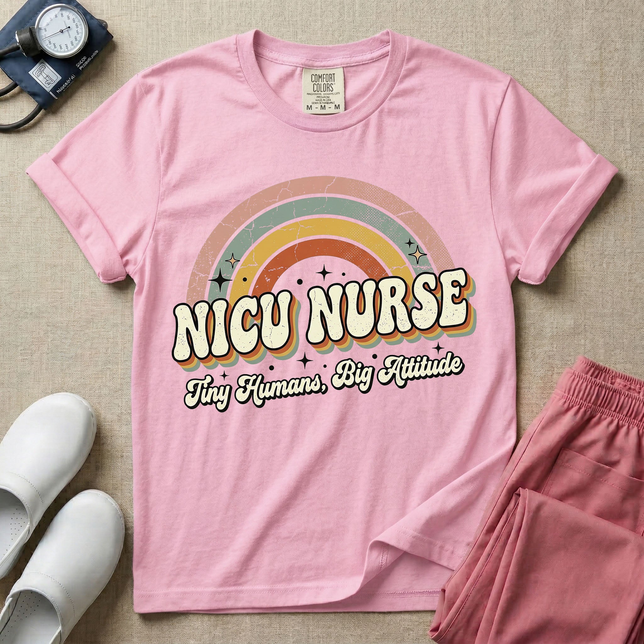 Neonatal Intensive Care Unit NICU nurse t-shirt with a retro vintage rainbow and tiny humans big attitude graphic in blossom color.