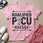 A funny pediatric intensive care nursing t-shirt featuring the pun text "KOALIFIED PICU nurse" with a cute koala graphic replacing the letter I in PICU, framed by decorative arrows and a pink medical cross.