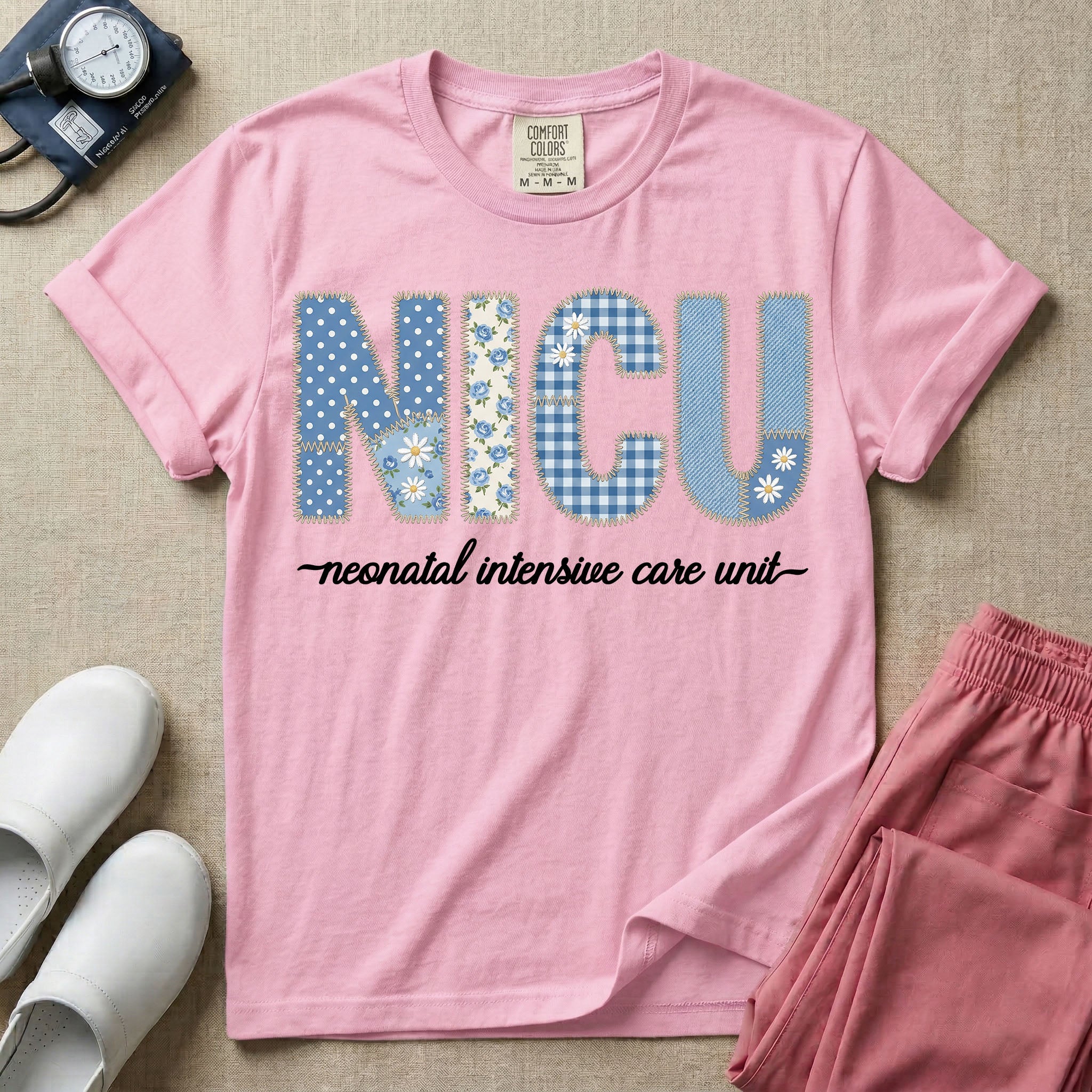 A t-shirt for NICU nurses featuring the large text "NICU" designed to look like faux embroidery with floral and plaid patterns, and the words "neonatal intensive care unit" written in a delicate script font underneath.