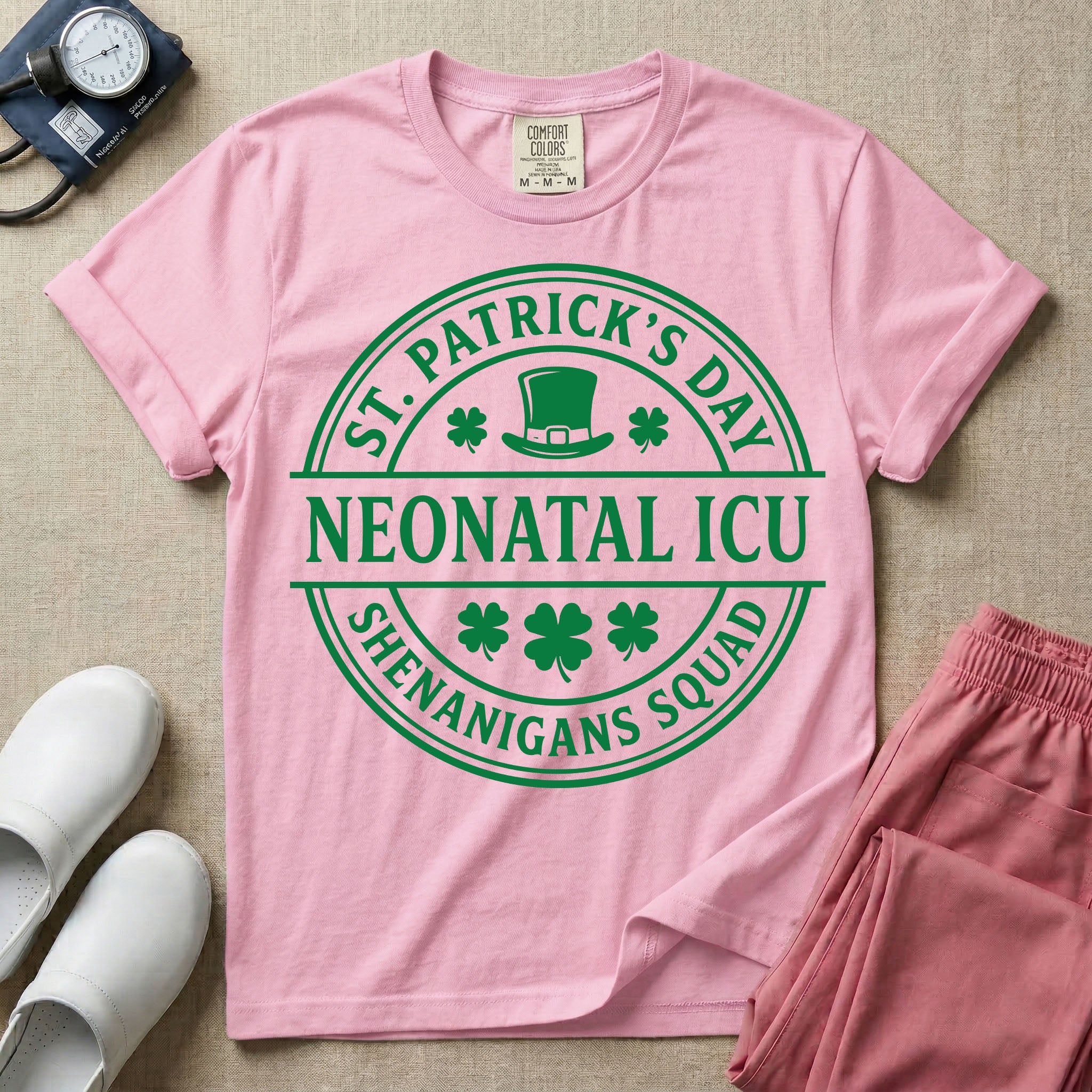 A circular green graphic featuring a leprechaun hat, shamrocks, and the text ST. PATRICK'S DAY SHENANIGANS SQUAD surrounding a center banner that reads NEONATAL ICU.