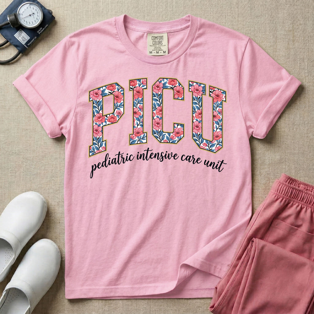 A boho pediatric intensive care nursing t-shirt featuring the large block text "PICU" filled with a decorative floral pattern, positioned above the cursive white text "pediatric intensive care unit".