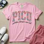 A boho pediatric intensive care nursing t-shirt featuring the large block text "PICU" filled with a decorative floral pattern, positioned above the cursive white text "pediatric intensive care unit".