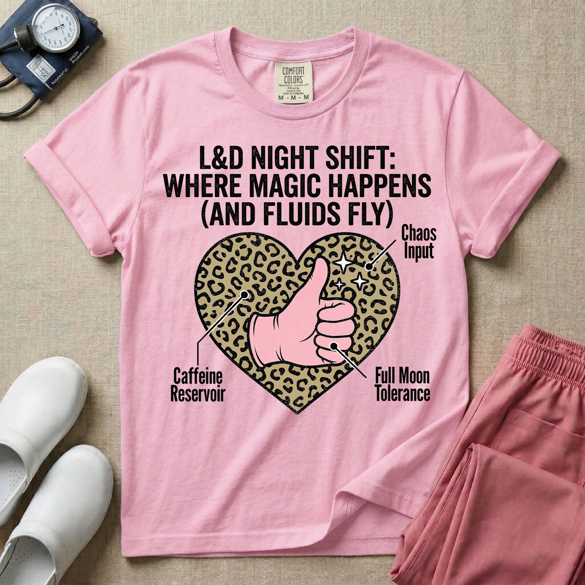 Labor and Delivery L&D nursing t-shirt featuring a leopard print heart diagram with a gloved thumbs-up and the text "L&D NIGHT SHIFT: WHERE MAGIC HAPPENS (AND FLUIDS FLY)"