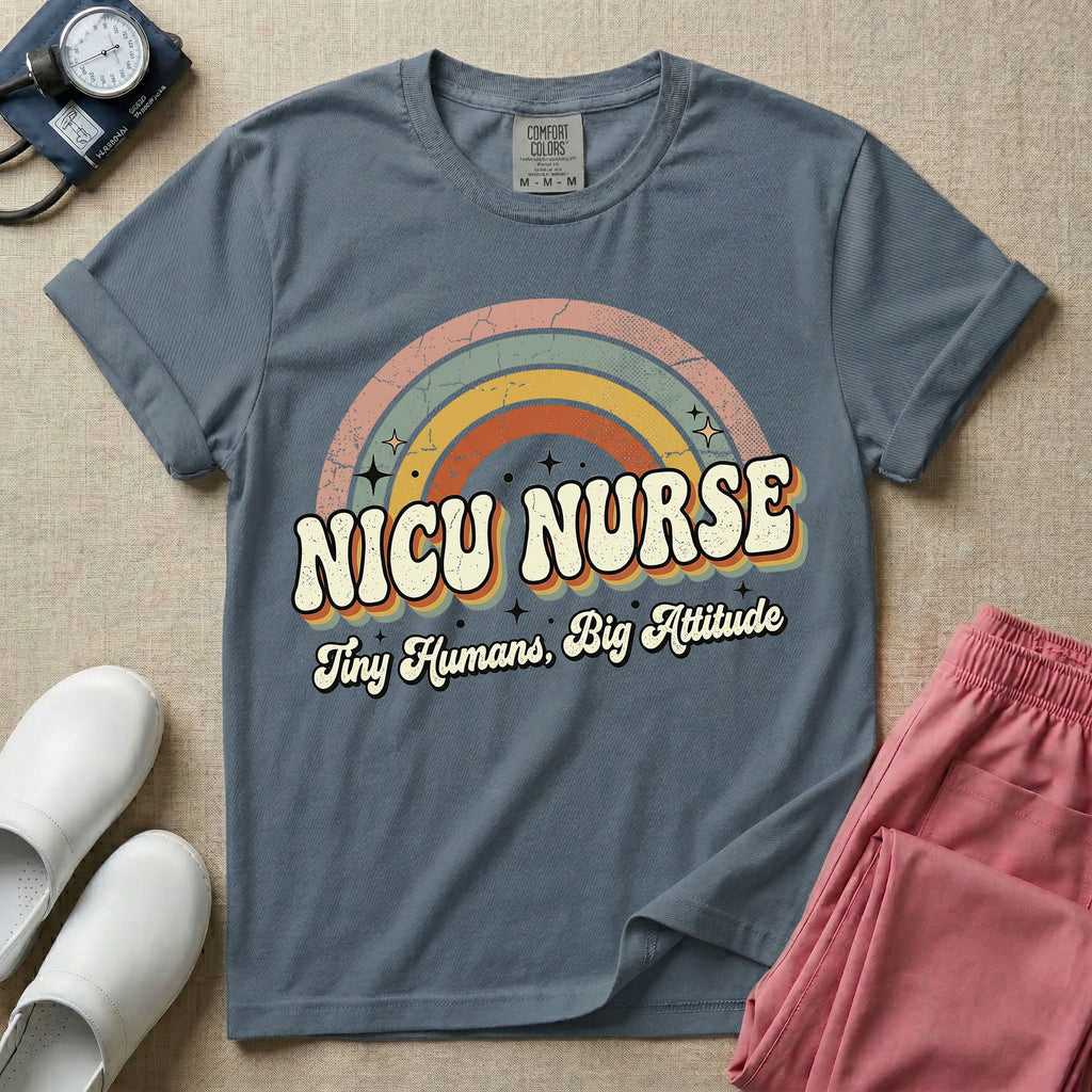 Neonatal Intensive Care Unit NICU nurse t-shirt with a retro vintage rainbow and tiny humans big attitude graphic in blue jean color.