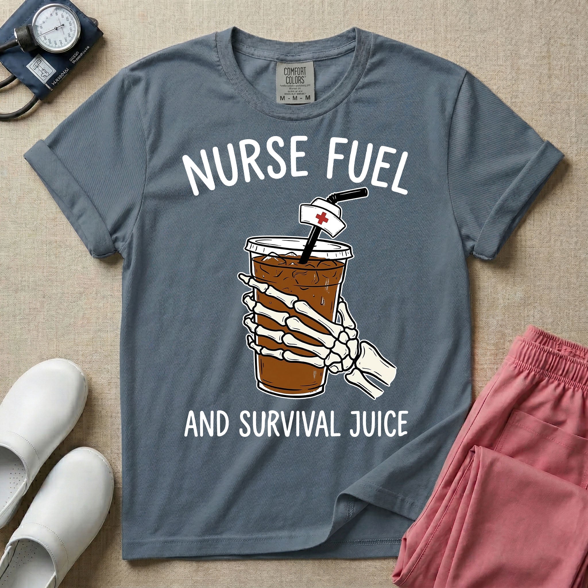 General nursing t-shirt featuring a graphic of a skeleton hand holding an iced coffee cup with a nurse cap on the straw and the text "NURSE FUEL AND SURVIVAL JUICE"