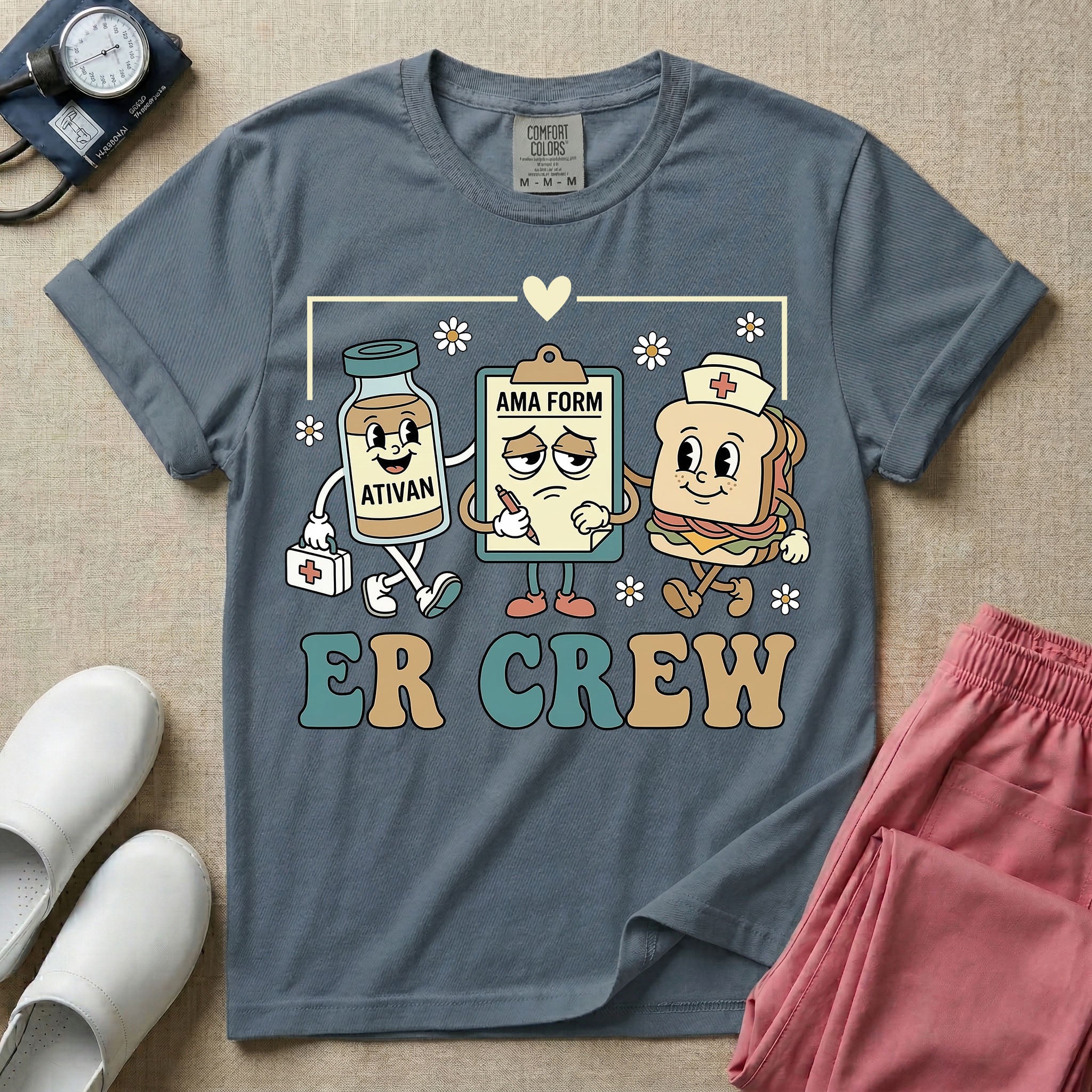 A retro-style t-shirt for emergency room nurses featuring the text "ER CREW" below a vintage cartoon illustration of a medicine bottle, a grumpy clipboard holding an AMA form, and a sandwich wearing a nurse cap walking together.