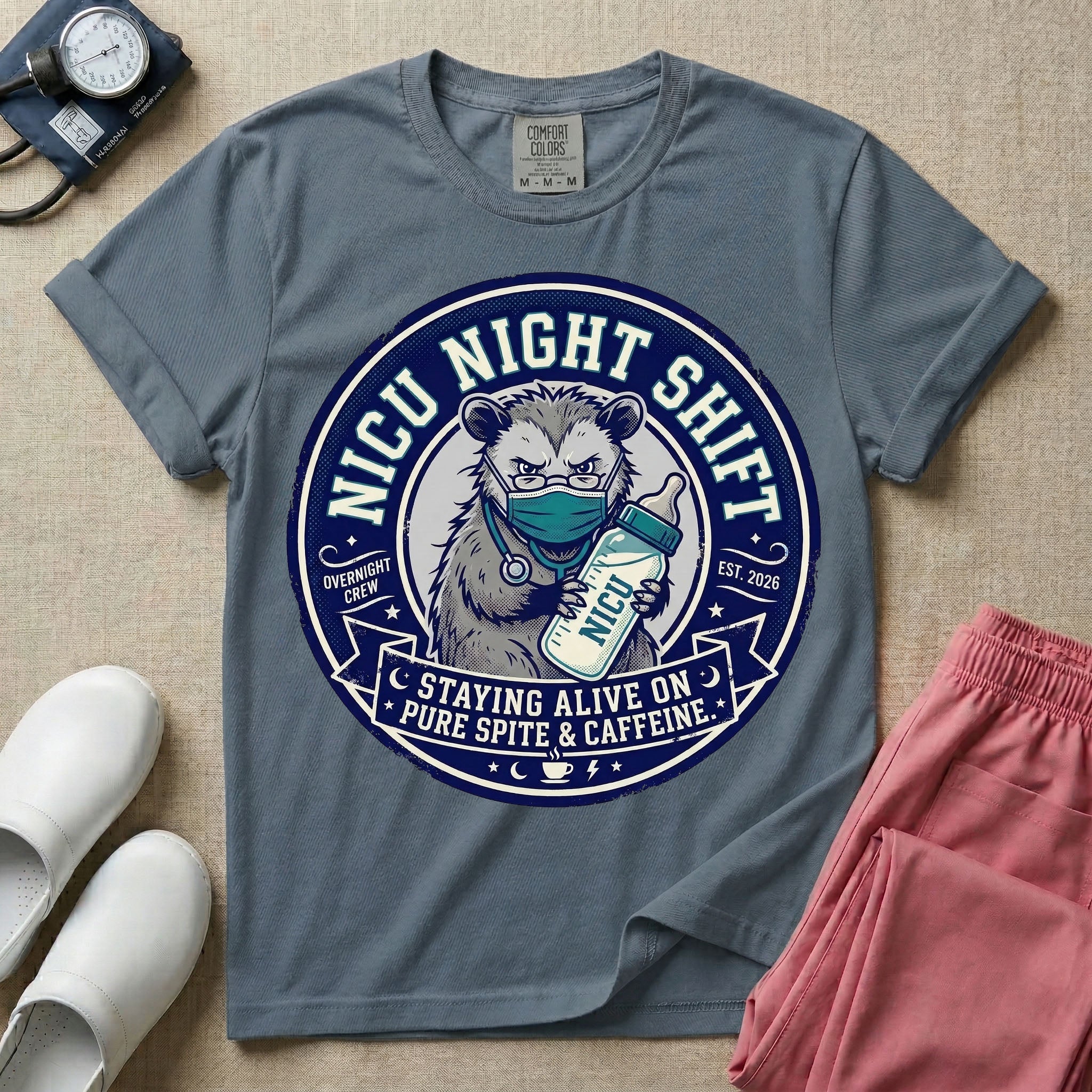 A humorous graphic for a Neonatal Intensive Care Unit featuring a circular design with an illustration of a tired raccoon wearing a medical face mask and holding a baby bottle labeled 'NICU', surrounded by the text 'NICU NIGHT SHIFT' at the top and 'STAYING ALIVE ON PURE SPITE & CAFFEINE' at the bottom.