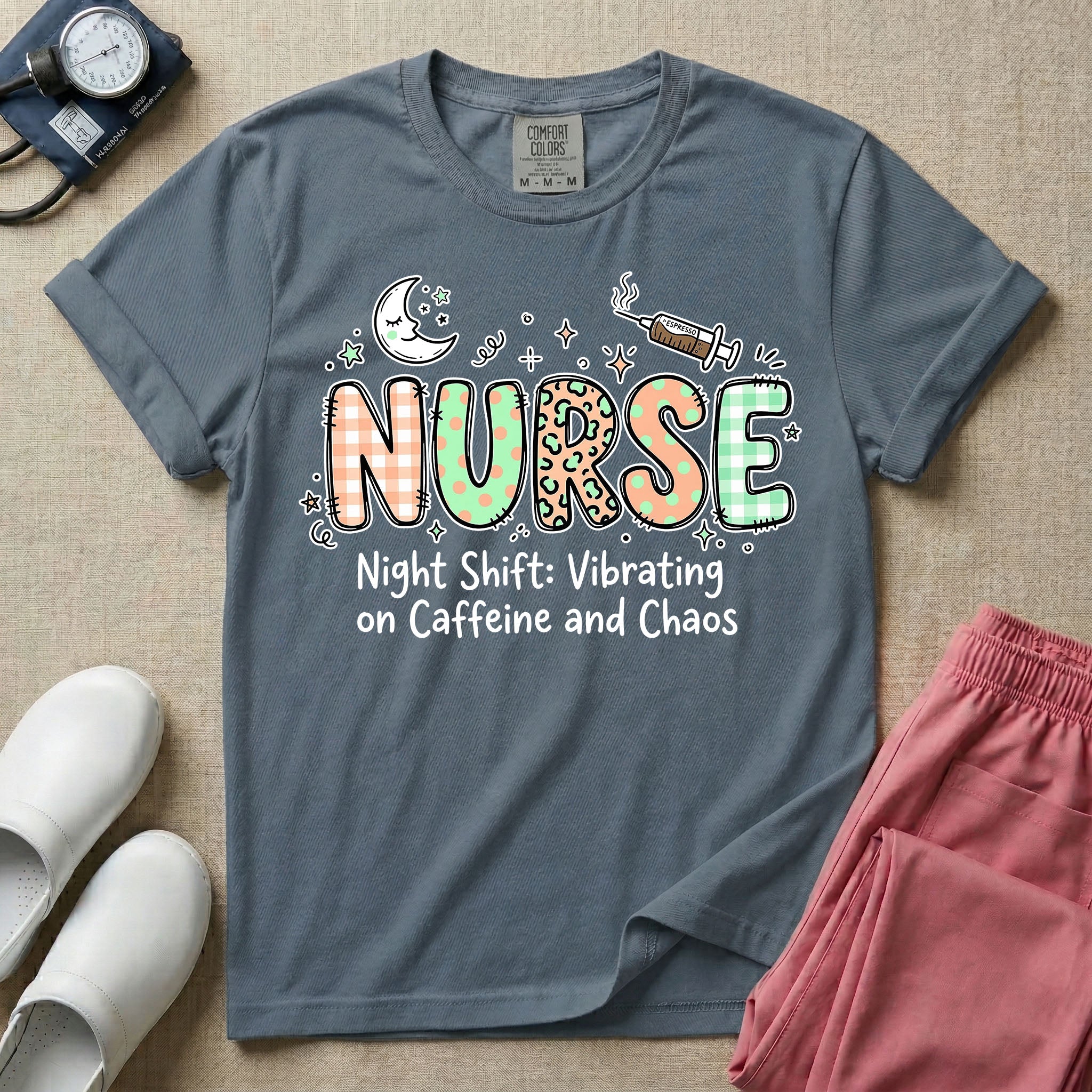A humorous General Nursing graphic featuring the word NURSE in large, playfully patterned letters including plaid, leopard print, and floral designs, accented by a sleeping crescent moon and a syringe, positioned above text that reads Night Shift: Vibrating on Caffeine and Chaos.