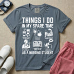 A t-shirt featuring the text THINGS I DO IN MY SPARE TIME AS A NURSING STUDENT surrounded by humorous line-art icons depicting studying, drinking coffee, and lacking sleep.