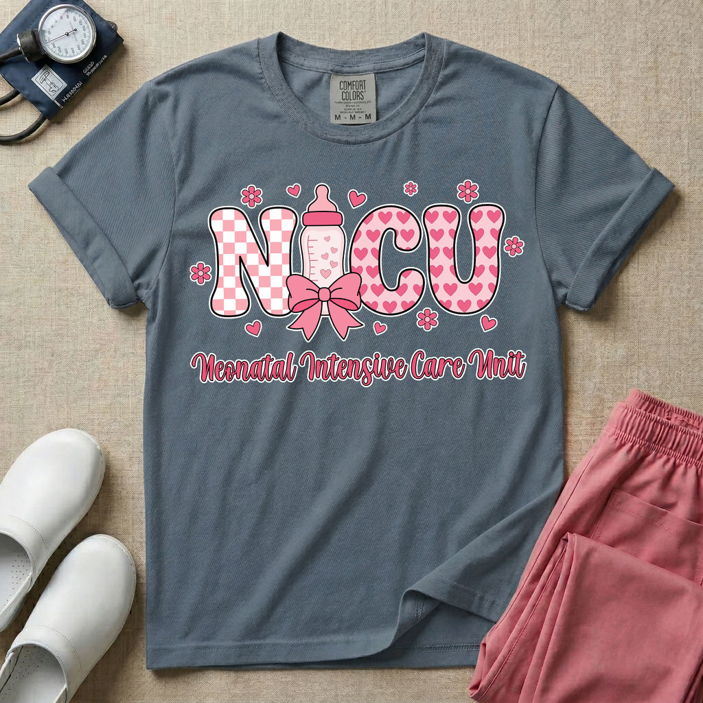Retro coquette style t-shirt graphic featuring decorative pink 'NICU' text with checkerboard and heart patterns, incorporating a baby bottle with a bow and hearts, and the cursive text 'Neonatal Intensive Care Unit' below.