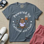 A humorous General Nursing graphic featuring an exhausted owl wearing scrubs and a nurse hat, hooked up to an IV bag labeled CAFFEINE NIGHT SHIFT FUEL, surrounded by coffee beans, stars, and moons, with circular text reading Powered by Caffeine and Chaos.