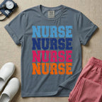 A t-shirt featuring the word NURSE repeated four times in a stacked vertical layout with a distressed, vintage texture in blue, navy, pink, and orange colors.
