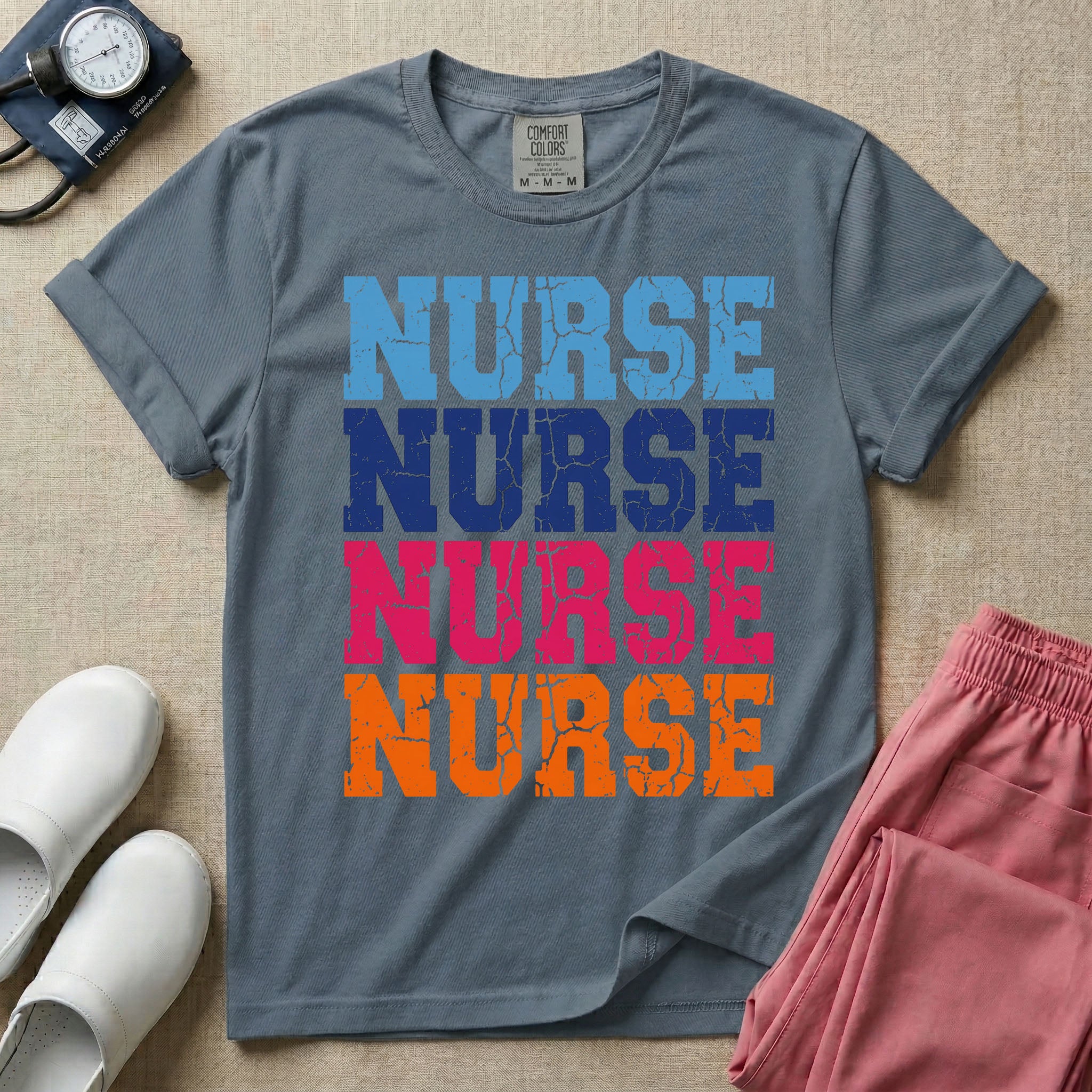 A t-shirt featuring the word NURSE repeated four times in a stacked vertical layout with a distressed, vintage texture in blue, navy, pink, and orange colors.