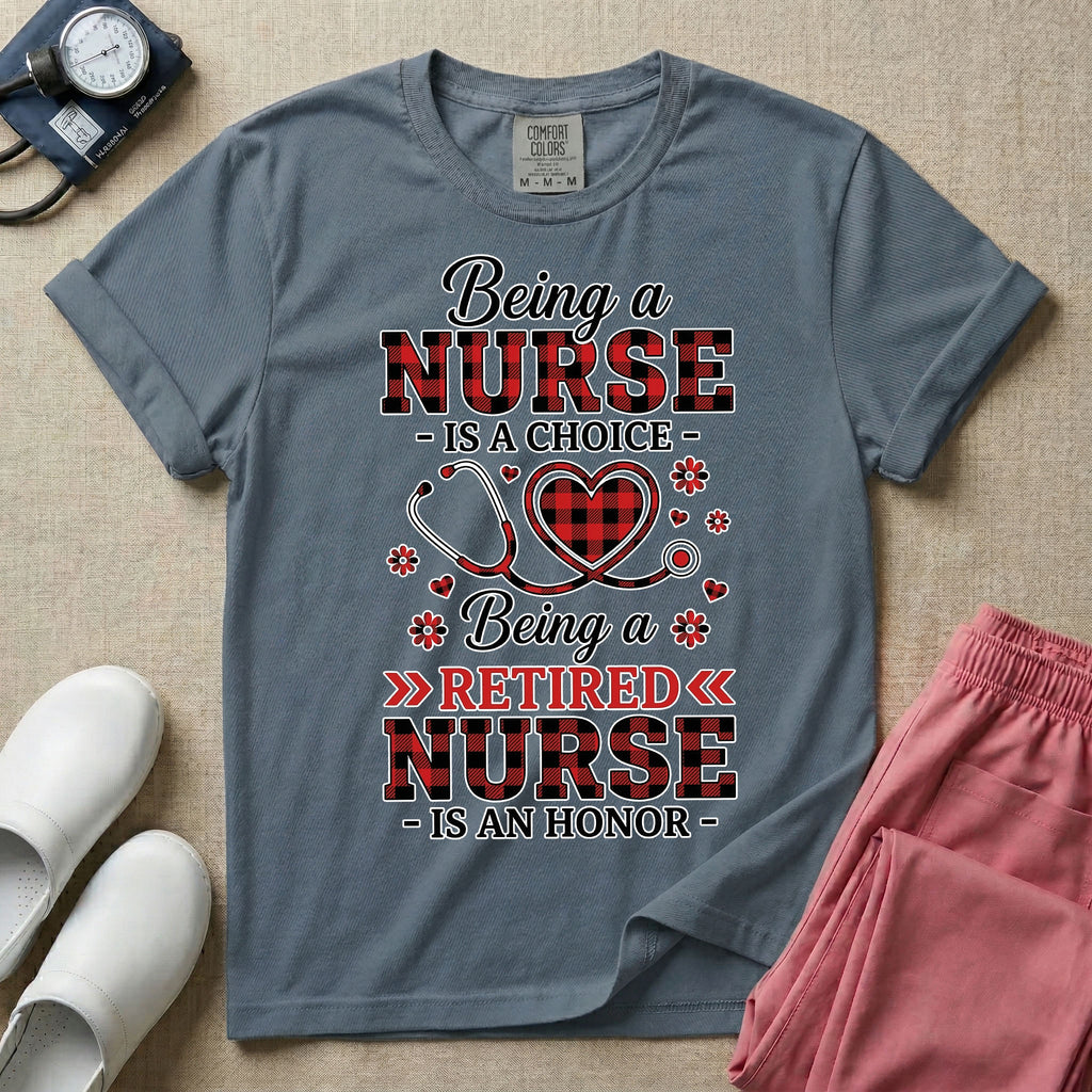 A t-shirt featuring the text Being a NURSE IS A CHOICE Being a RETIRED NURSE IS AN HONOR surrounding a central graphic of a red and black buffalo plaid heart intertwined with a stethoscope.