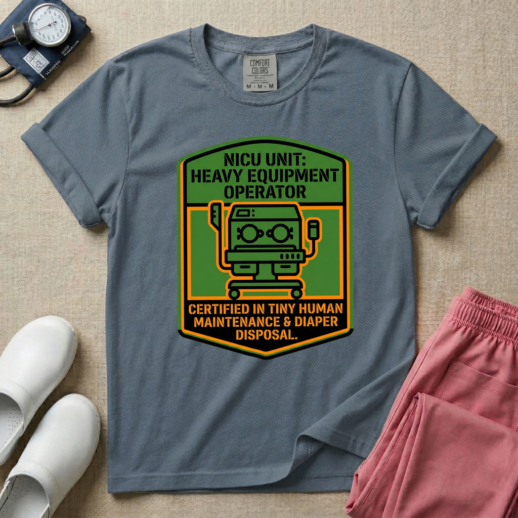 A graphic resembling a patch with green borders and orange inner sections featuring an illustration of a medical incubator in the center, with the text 'NICU UNIT: HEAVY EQUIPMENT OPERATOR' at the top and 'CERTIFIED IN TINY HUMAN MAINTENANCE & DIAPER DISPOSAL' at the bottom.