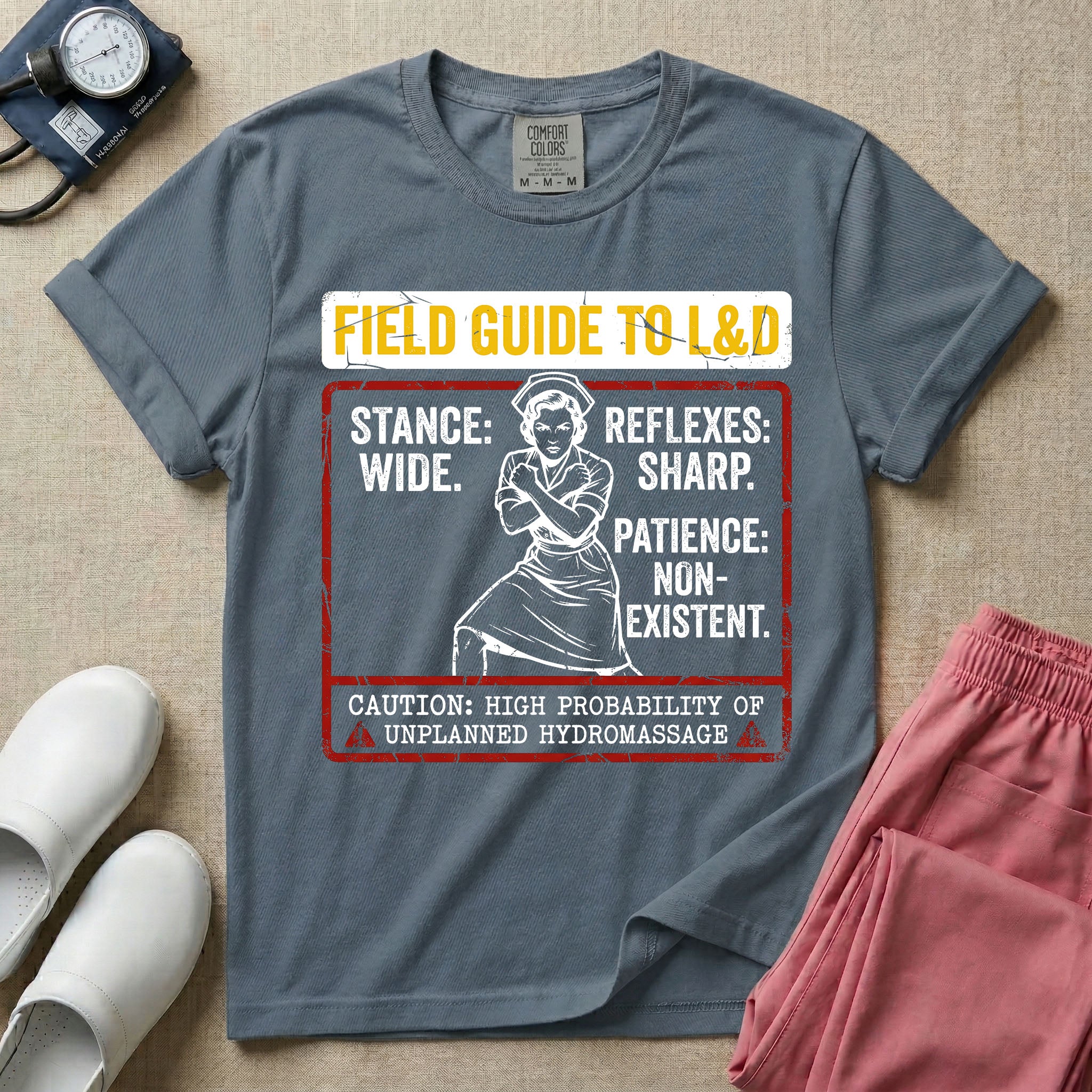 A humorous and retro graphic tee for labor and delivery nurses featuring a vintage nurse illustration alongside the text "FIELD GUIDE TO L&D", "STANCE: WIDE", "REFLEXES: SHARP", "PATIENCE: NON-EXISTENT", and "CAUTION: HIGH PROBABILITY OF UNPLANNED HYDROMASSAGE".